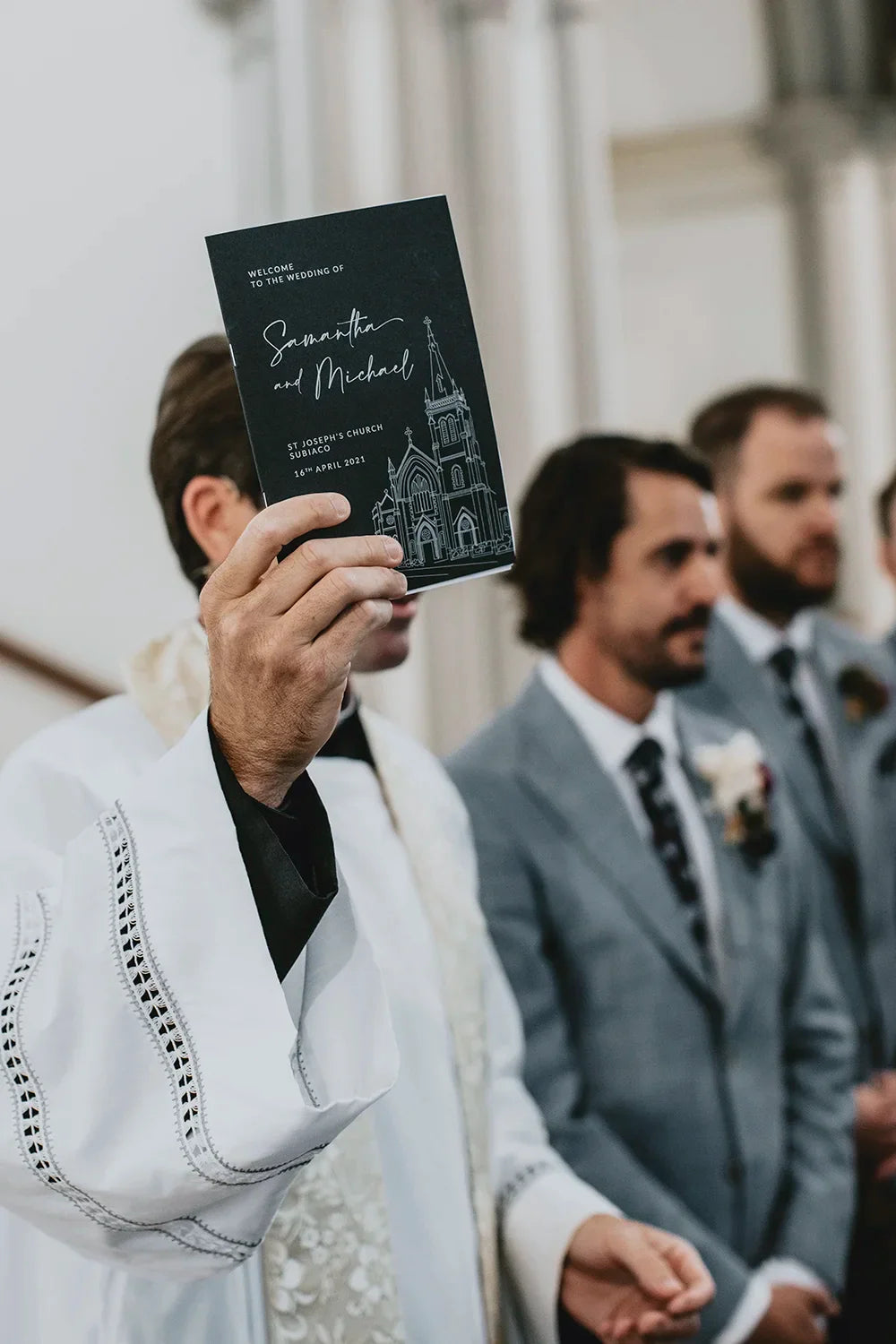 Wedding ceremony booklet for Samantha and Michael at St Josephs Church Subiaco held by priest