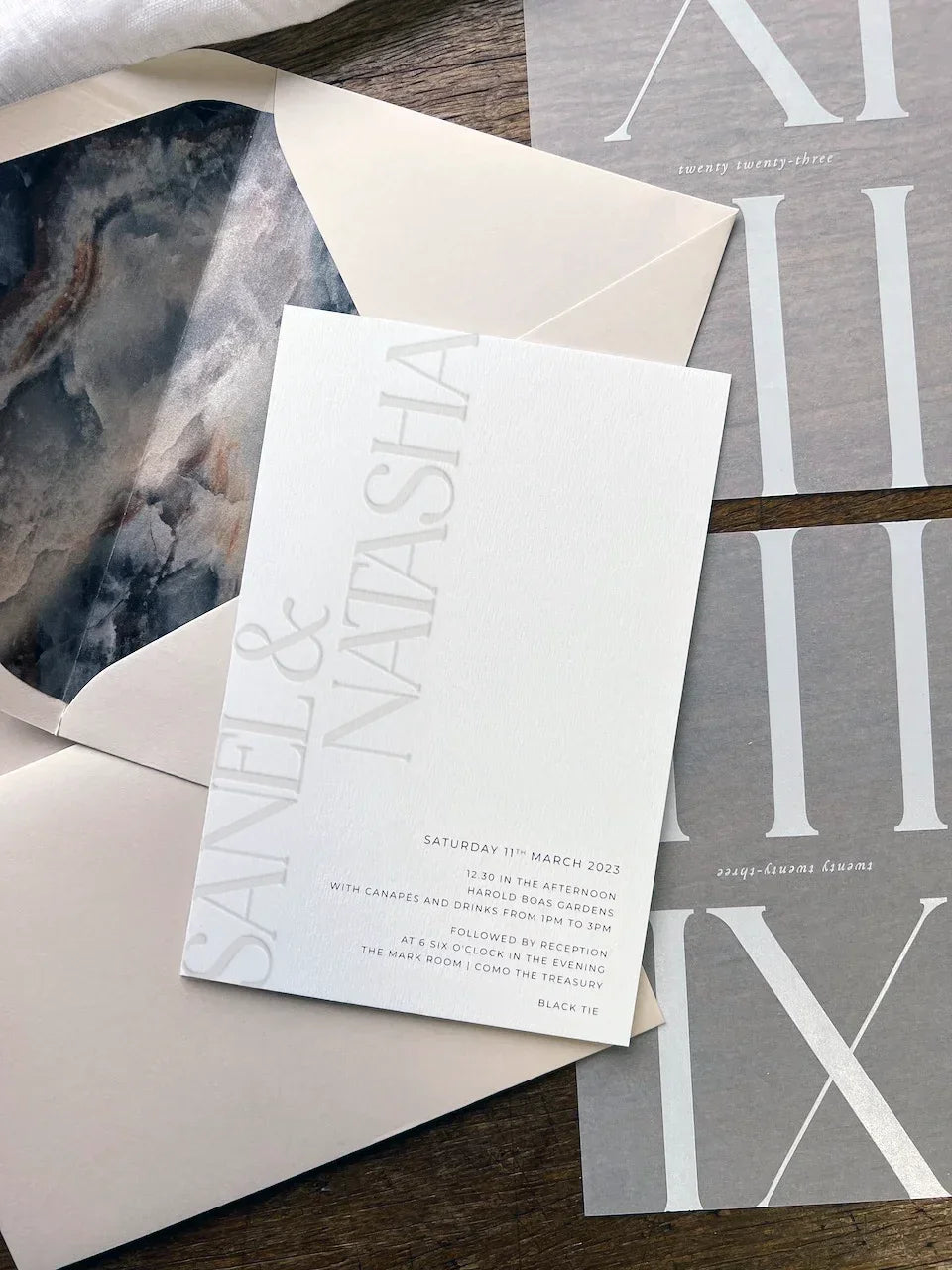 Elegant Natasha and Sanel wedding invitation on textured cardstock with marble envelope lining