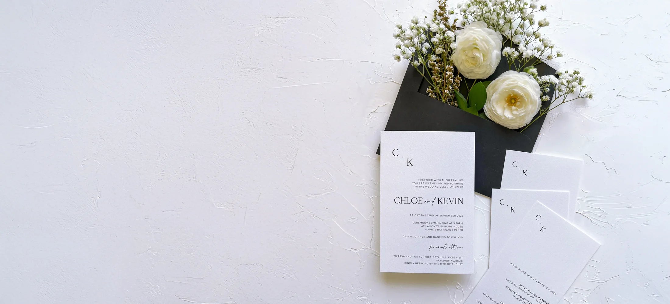 A minimalist wedding invitation suite with a modern 'CK' monogram, showcasing the clean design and quality backed by our no-compromise guarantee.