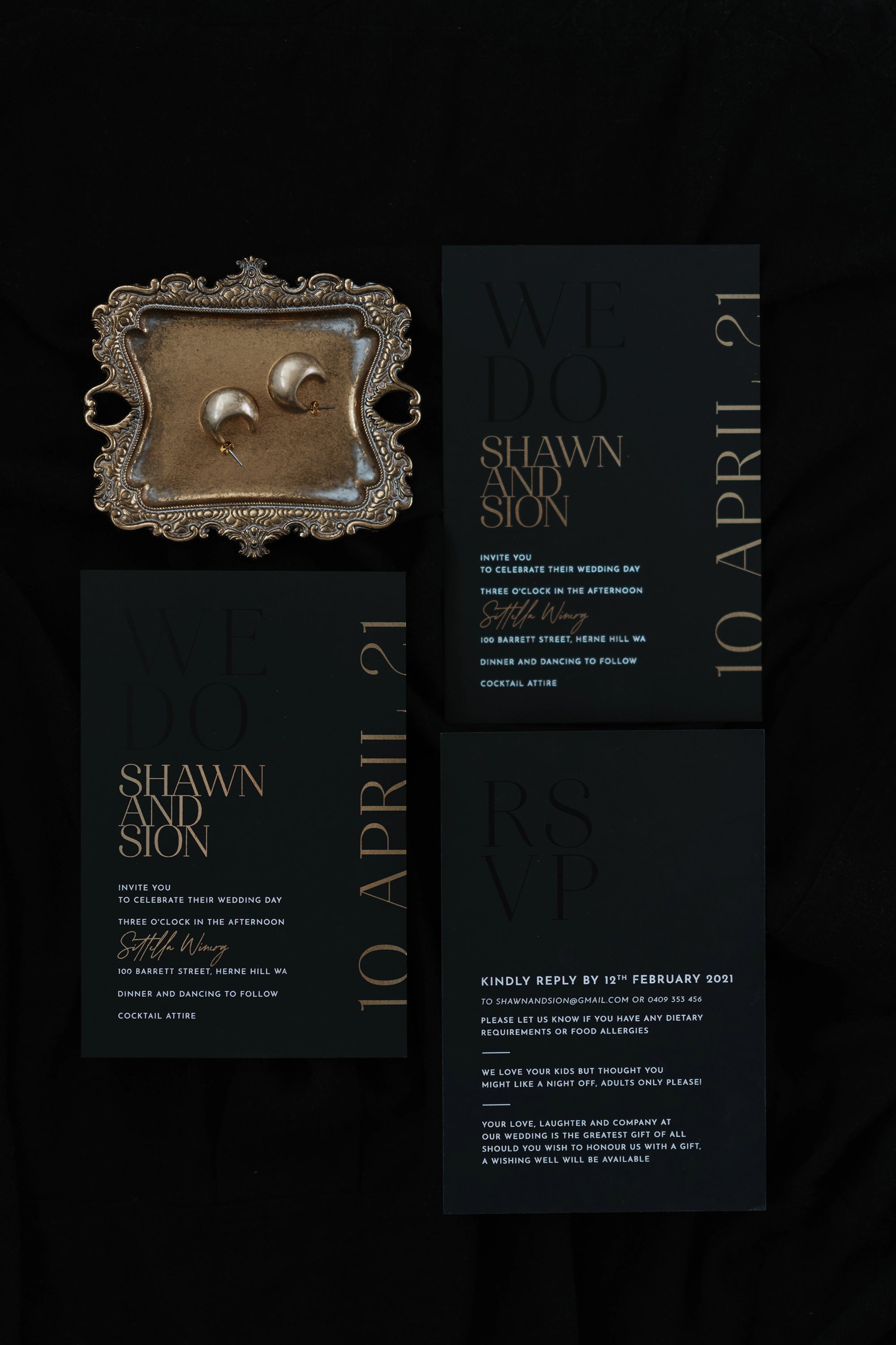 The Monaco suite flat-lay — black wedding invitation suite with rose gold foil for Shawn and Sion at Sittella Winery, with ornate brass tray and gold earrings