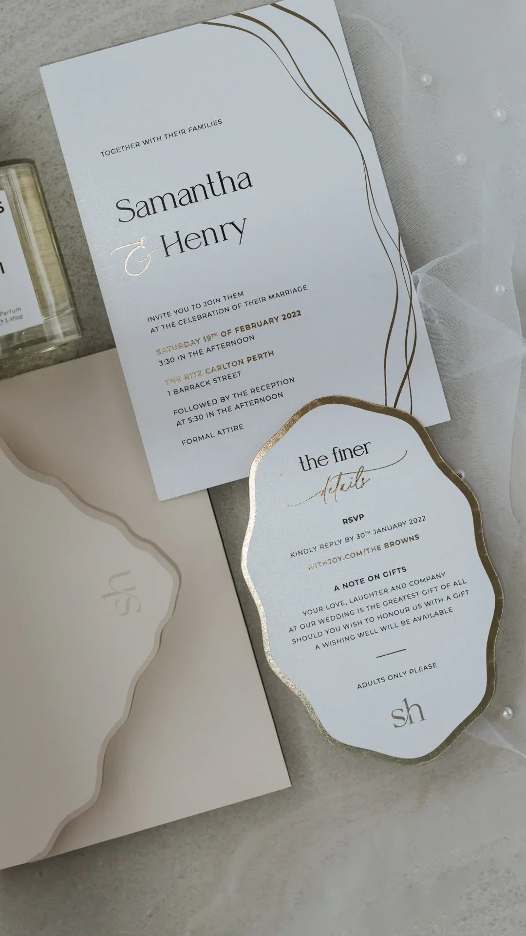 Elegant Samantha & Henry wedding invitations with gold foil details and curved edges on beige background