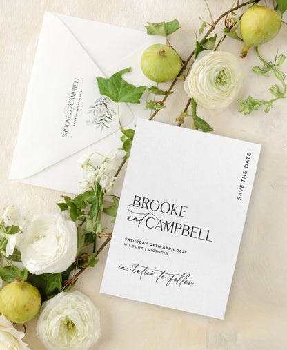 An elegant letterpress Save the Date and matching envelope for a Mildura, Victoria wedding, styled with white ranunculus and fresh ivy.