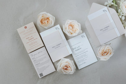 Elegant letterpress wedding invitations for Amy and Andrew with white roses on concrete