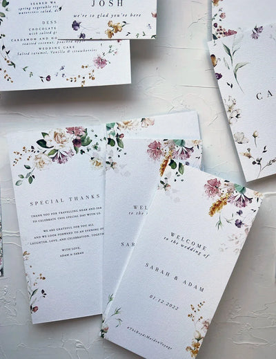 Tri-fold wedding program with watercolor floral border for Sarah and Adam wedding ceremony by Felicitations