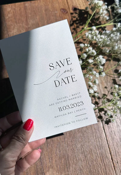 Modern minimalist Save the Date for Rachel and Brett 11.03.2023 Matilda Bay Perth, sleek typography on grey card with baby's breath