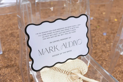 Memorial wedding sign for Mark Audino, father of the bride, on a clear chair with woven fan