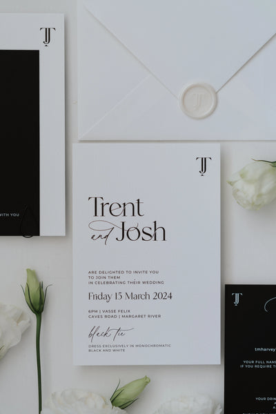 The Copenhagen Suite white wedding invitation with TJ monogram and white wax seal envelope on lisianthus flowers by Felicitations