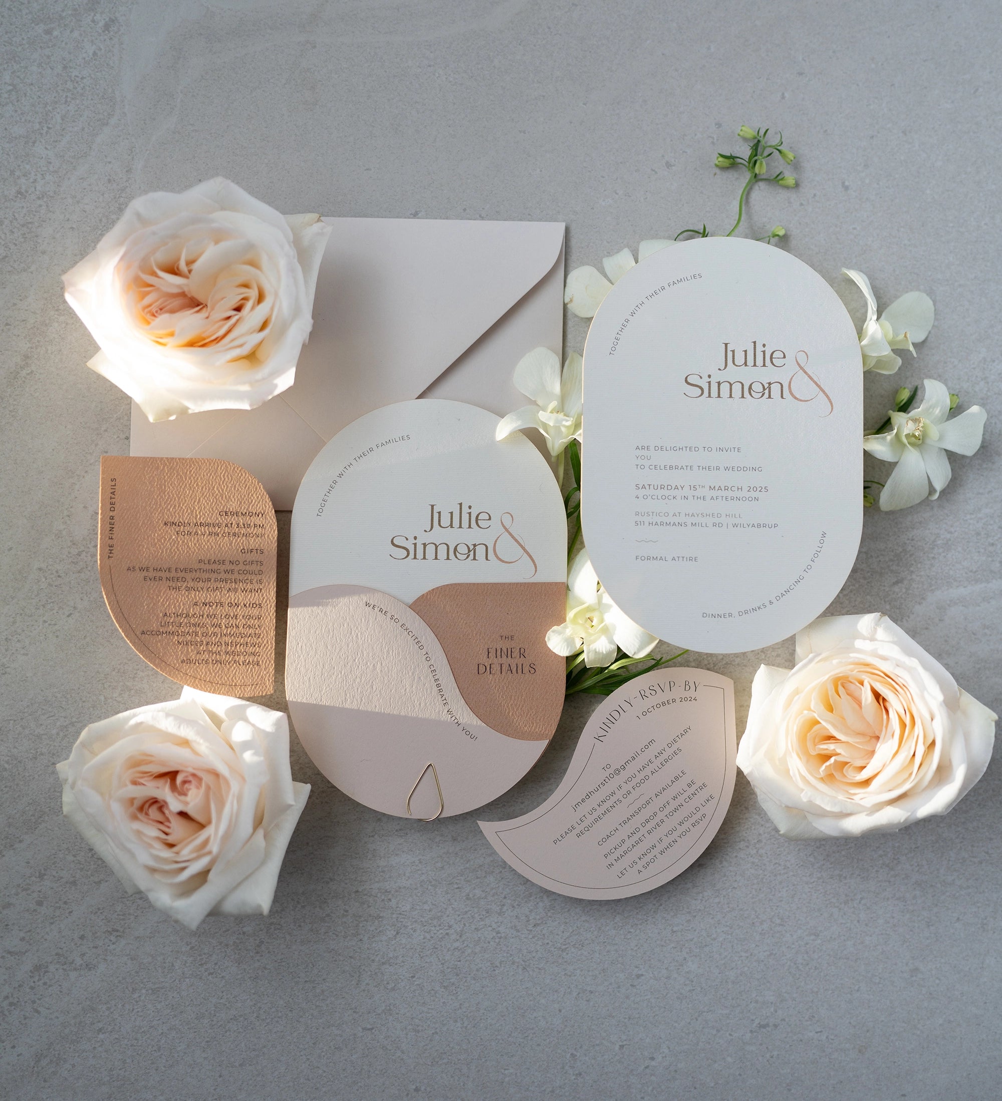 The Dolomites Suite full wedding stationery flat lay with copper foil arch invitation finer details RSVP and white roses by Felicitations