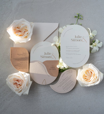 The Dolomites Suite full wedding stationery flat lay with copper foil arch invitation finer details RSVP and white roses by Felicitations