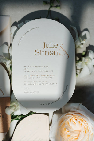 The Dolomites Suite oval arch wedding invitation in cream with copper foil typography for Julie and Simon by Felicitations