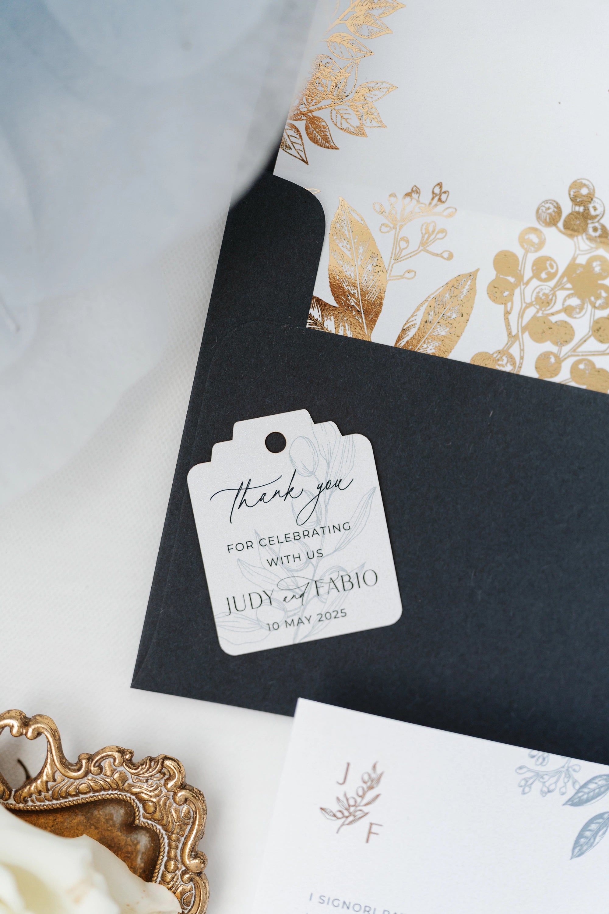 The Geneva Suite thank you tag with calligraphy on black envelope with gold foil envelope liner by Felicitations Wedding Stationery