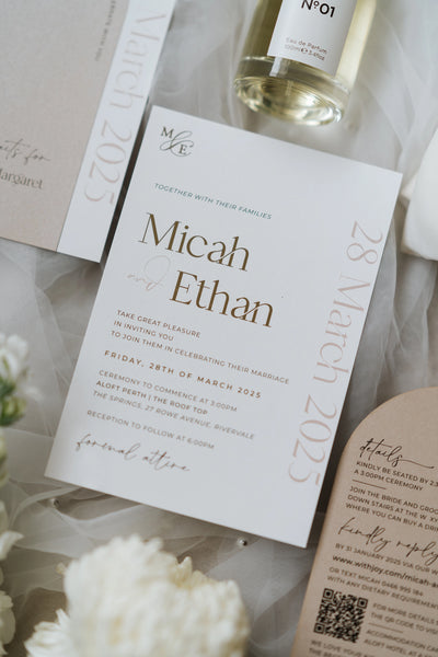 The Matera Suite wedding invitation flat lay with seat reservation card and Stories perfume bottle by Felicitations