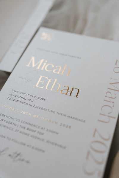 The Matera Suite shimmer pearl wedding invitation close up with rose gold foil names by Felicitations Wedding Stationery