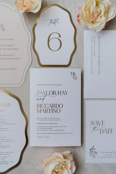 The Paris suite full set — invitation, save the date, gold-edged table number, RSVP card and printed envelope flat-lay for Taylor and Riccardo's Millbrook Winery wedding