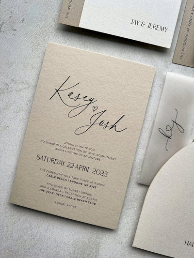 The Portofino Suite cream wedding invitation Kasey and Josh with kraft envelope and vellum wrap by Felicitations