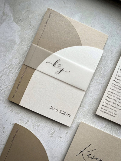 The Portofino Suite cream wedding invitation with vellum belly band kj monogram for Jay and Jeremy by Felicitations