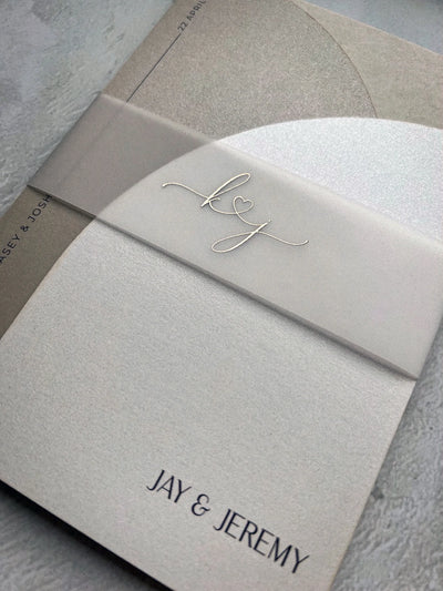 The Portofino Suite vellum belly band with calligraphy kj monogram on cream invitation for Jay and Jeremy by Felicitations