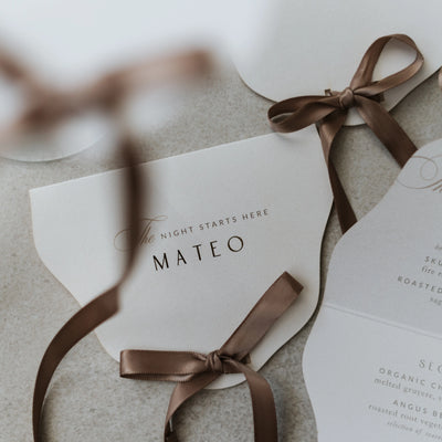 Mateo wedding menu card with brown ribbon ties and elegant typography by Felicitations