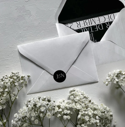 The St Moritz Suite white envelope with black JN monogram seal and black liner by Felicitations Wedding Stationery