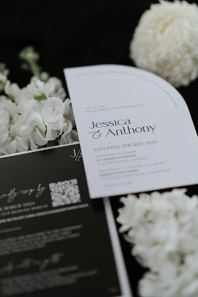 The Stockholm Suite arch shaped wedding invitation close up with JA monogram and black finer details card by Felicitations