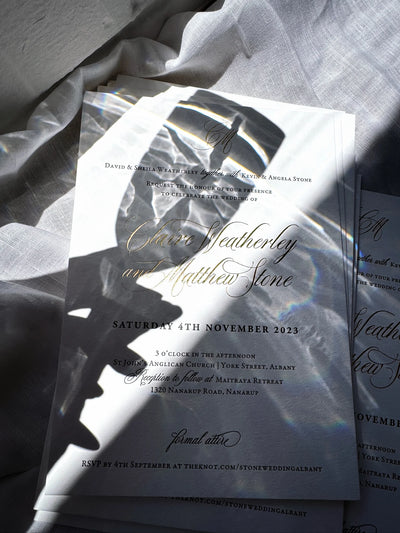 The Venice Suite traditional wedding invitation with gold foil calligraphy for Claire Weatherley and Matthew Stone with prism light reflection by Felicitations