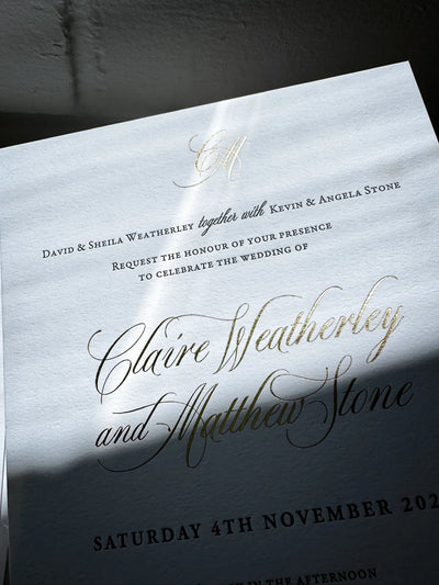 The Venice Suite close up of gold foil script calligraphy with CM monogram on traditional wedding invitation by Felicitations