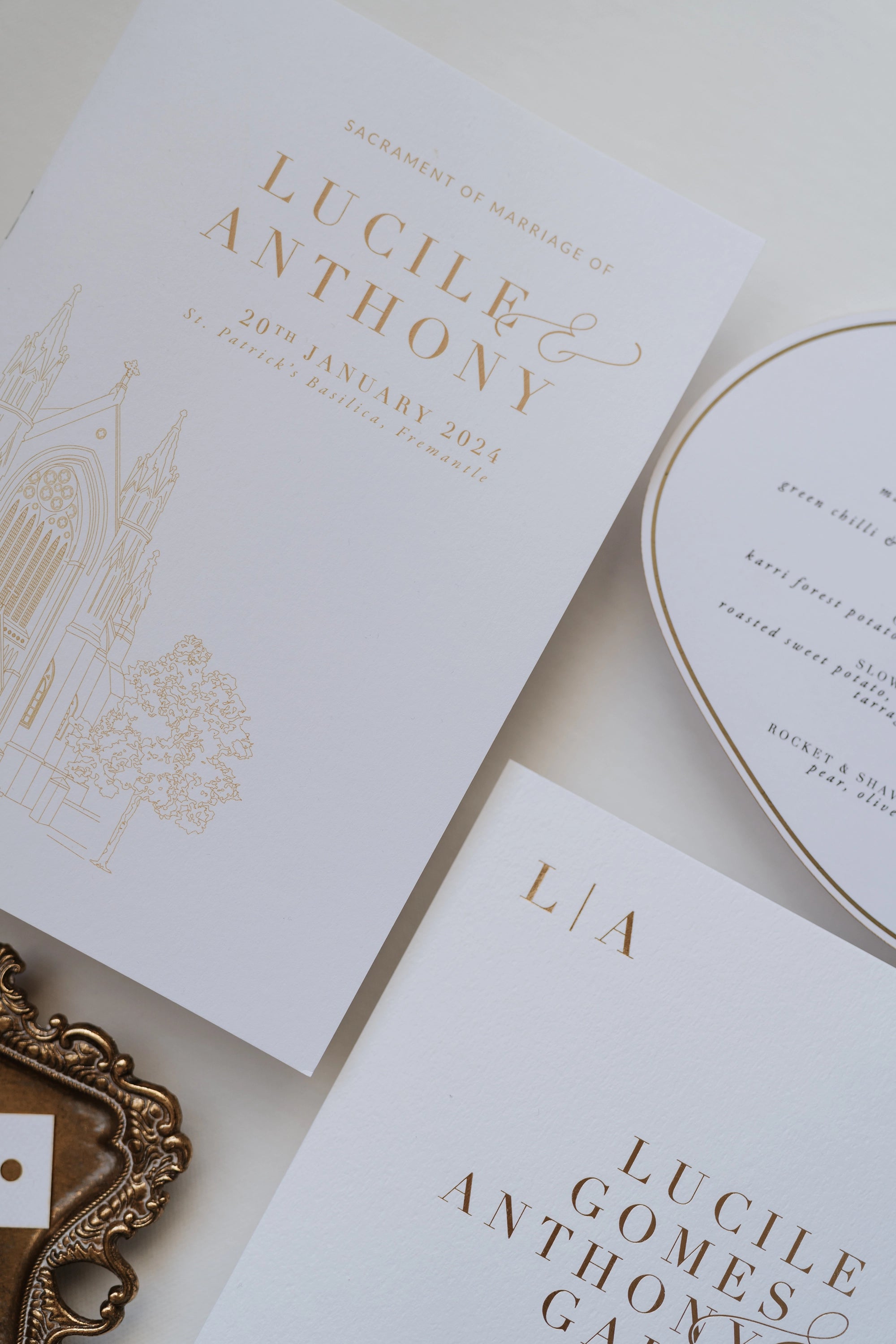 The Zurich Suite ceremony booklet detail with church illustration and gold foil typography by Felicitations Wedding Stationery
