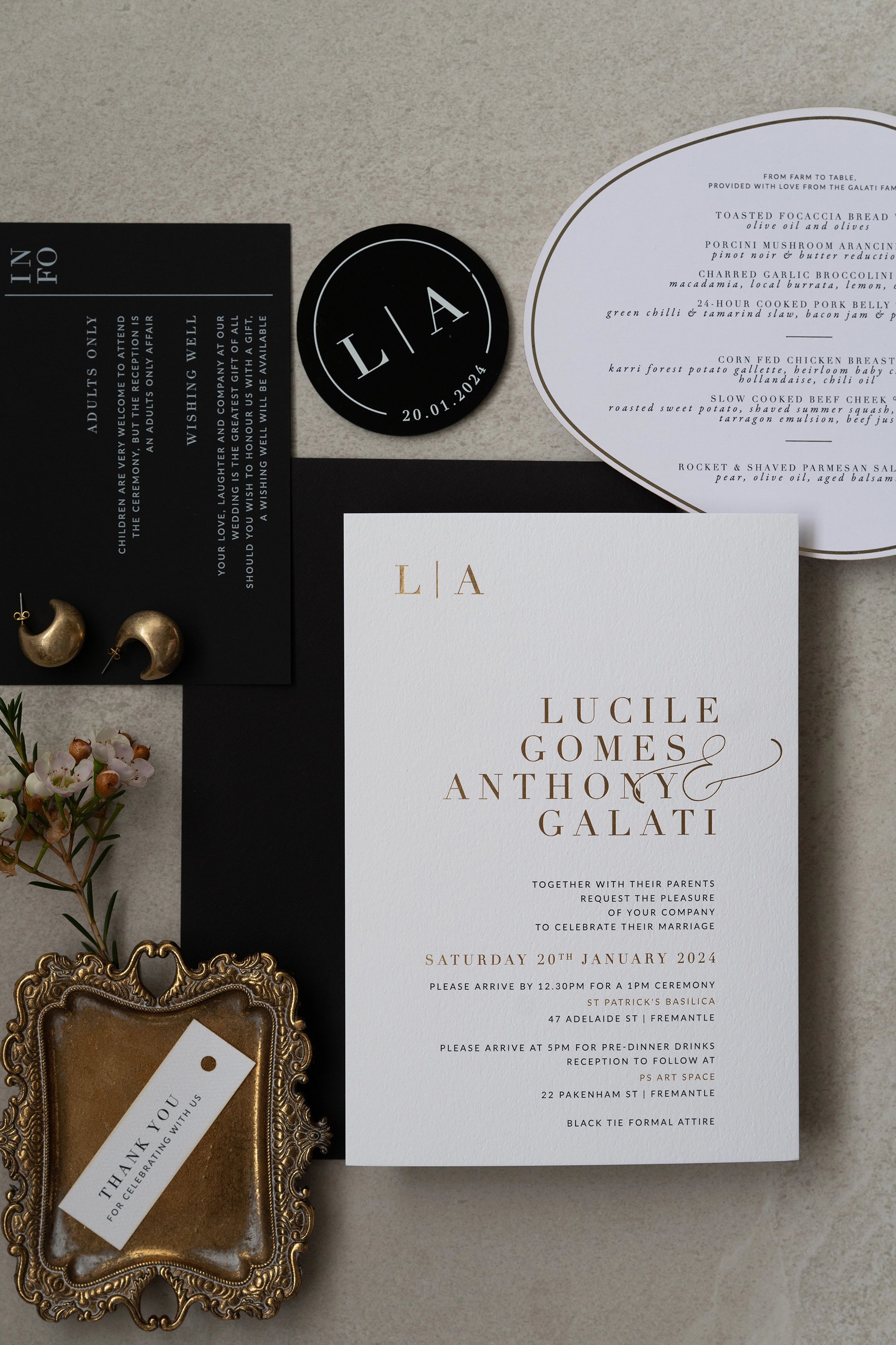The Zurich Suite full wedding stationery flat lay with gold foil invitation black info card and arch shaped menu by Felicitations